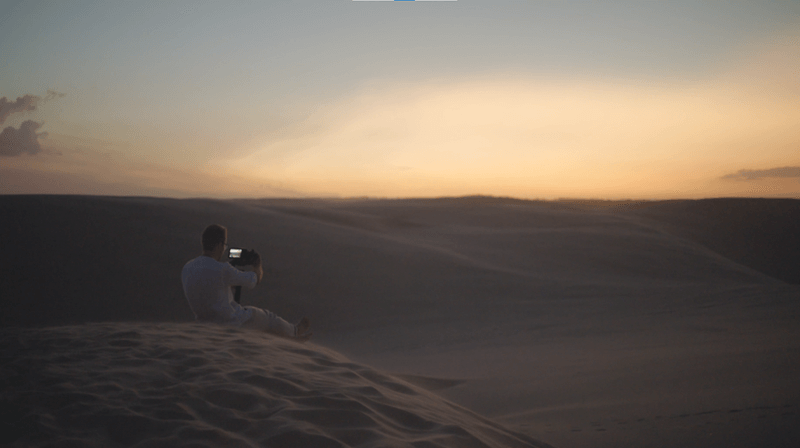 man shooting dunes in low light